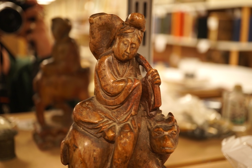 Chinese items comprising a soapstone carving, three jade carvings, one with gilt metal pendant mounts and two brass knops